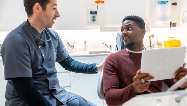 A dentist using the OrthoPhoto app with a patient
